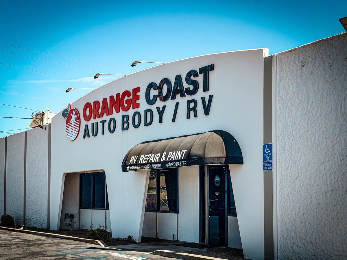 The Orange Coast Auto Body / RV building sign at 10810 Talbert Avenue in Fountain Valley